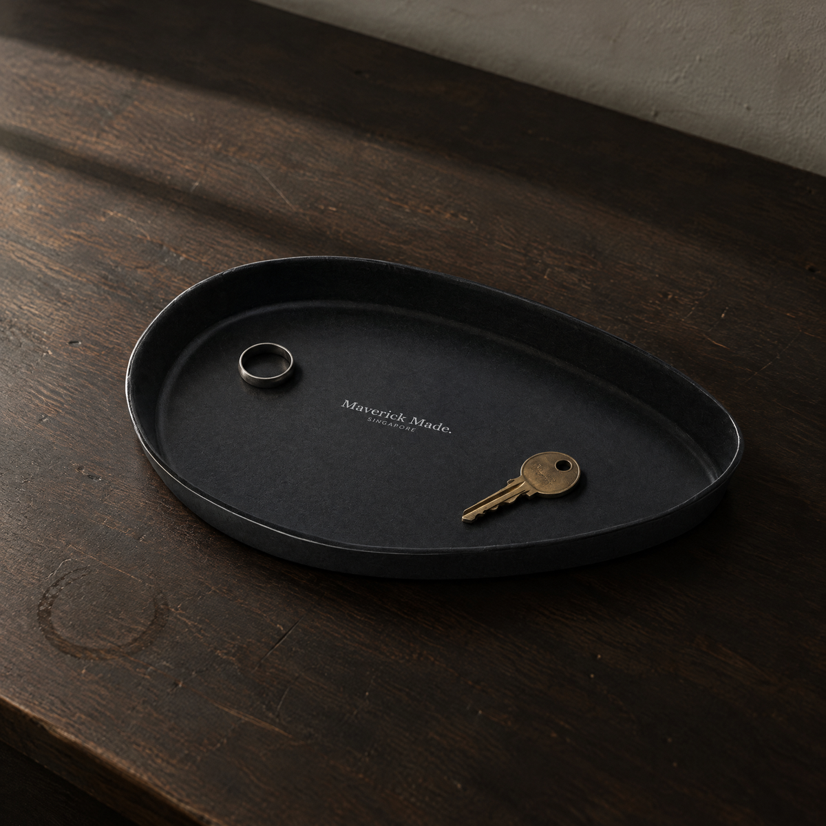 Black leather valet tray on wooden countertop
